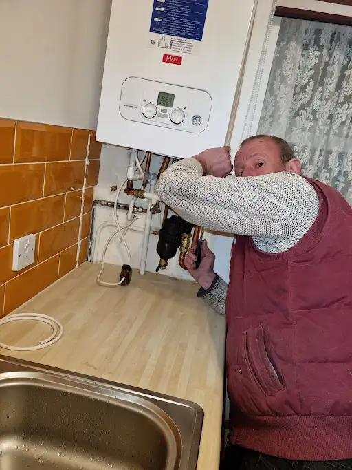 Plumber working on a domestic boiler in Stoke-on-Trent
